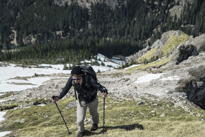 High angle view of man hiking on mountain