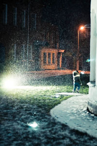 Low angle view of woman standing at night