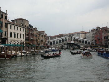 Boats in canal with buildings in background