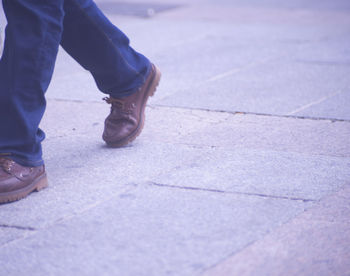 Low section of man standing on footpath