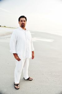 Portrait of smiling man standing in sea
