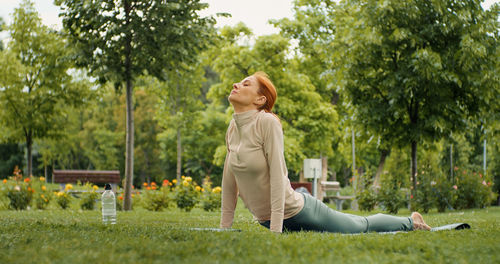 Woman doing stretching exercises in the park. 