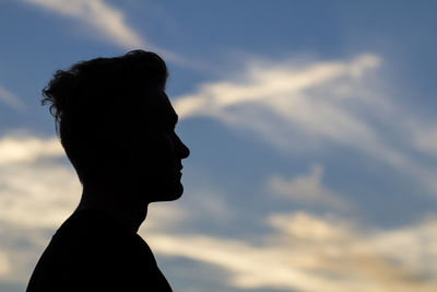 Low angle view of silhouette statue against sky