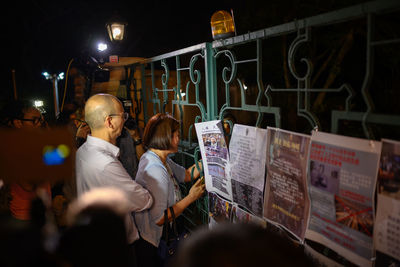 People standing in illuminated shop