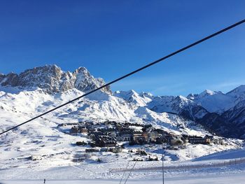 Snow covered mountain against blue sky