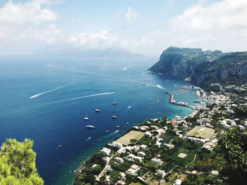 High angle view of sea and cityscape against sky