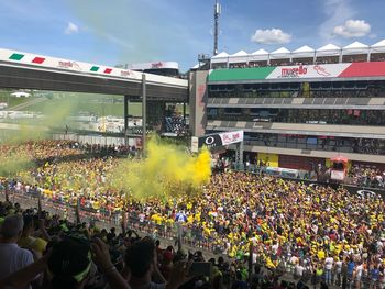 Crowd in city against sky