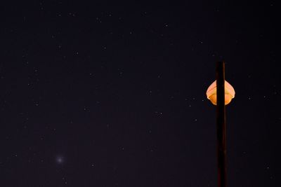 Low angle view of street light against sky at night