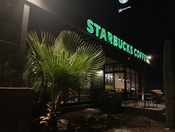 Low angle view of illuminated sign at night