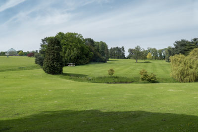 Scenic view of golf course against sky