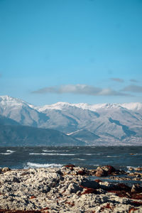 Scenic view of sea and mountains against sky