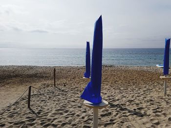Lifeguard hut on beach against sky