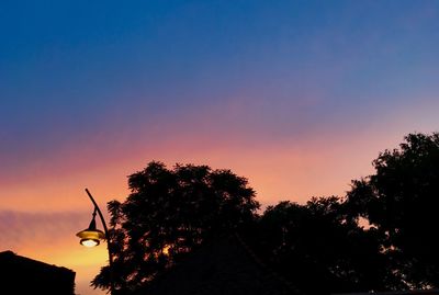 Silhouette trees against sky during sunset