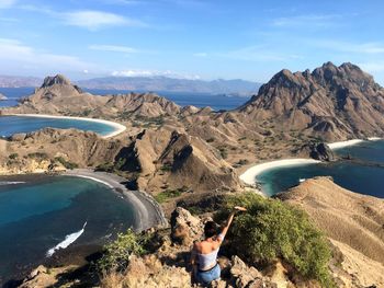 Scenic view of sea and mountains against sky