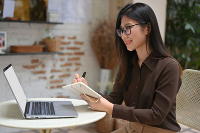 Woman using laptop on table