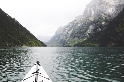 Scenic view of lake by mountains against clear sky