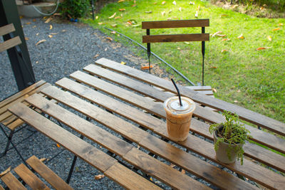 High angle view of wooden chairs and table in park