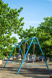 Playground in park against blue sky