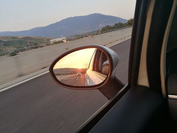 Cropped image of side-view mirror car with reflection