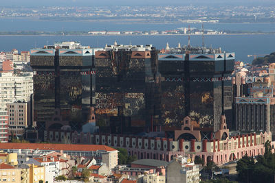 Cityscape by sea against sky