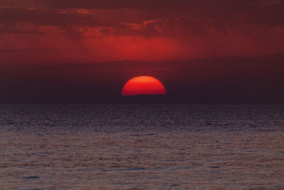 Scenic view of sea against orange sky