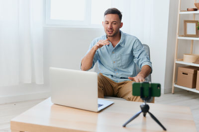 Young man using laptop while sitting at home