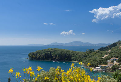 Scenic view of sea and mountains against sky