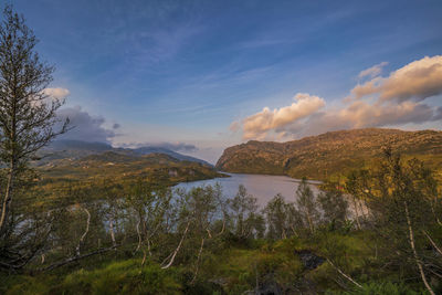 Scenic view of lake and mountains against sky