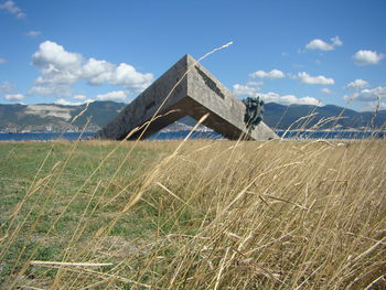 Built structure on field against sky