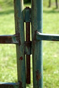 Close-up of rusty metal on field