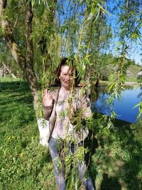 Woman standing by tree