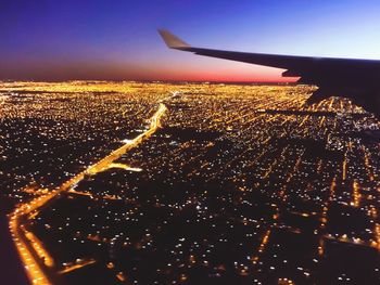 Aerial view of illuminated airplane wing