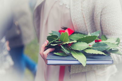 Midsection of woman holding christmas tree