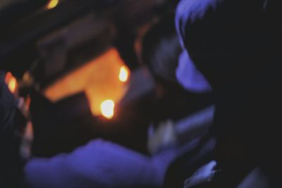 Close-up of lit candle in the dark