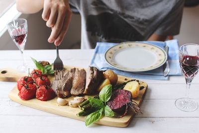 Close-up of hand with meal on table