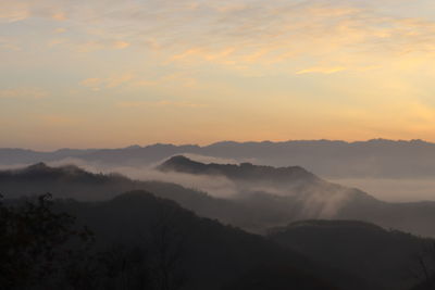 Scenic view of silhouette mountains against sky during sunset