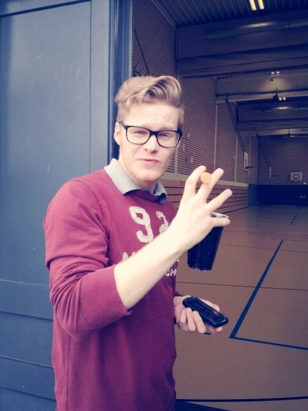 person, casual clothing, indoors, lifestyles, front view, young men, young adult, looking at camera, leisure activity, holding, portrait, three quarter length, sitting, smiling, waist up, happiness, communication