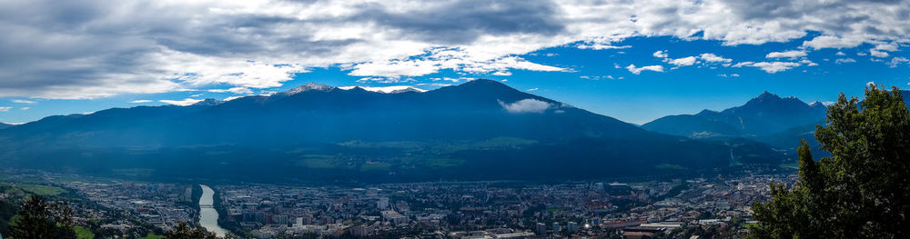Aerial view of buildings and mountains against sky
