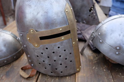 Close-up of traditional helmets on wooden table