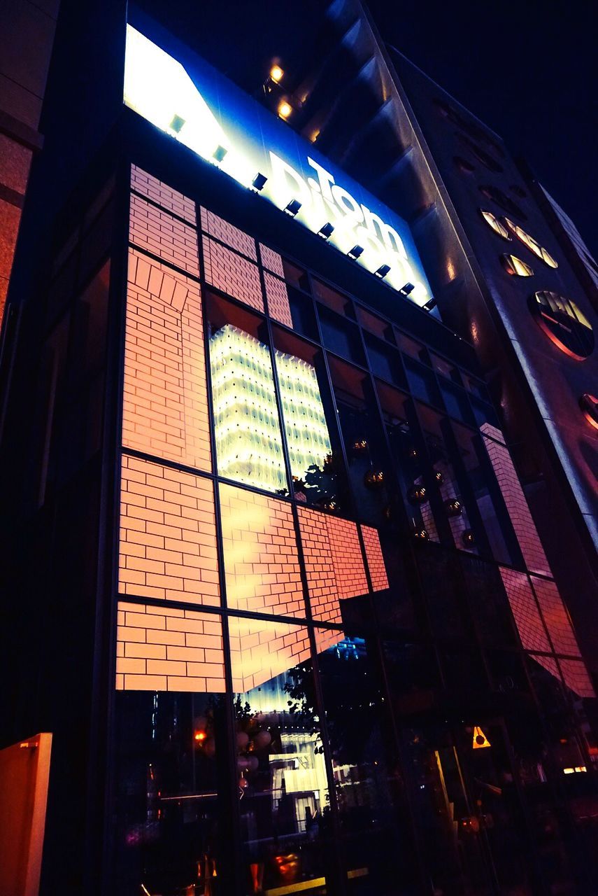 architecture, built structure, building exterior, low angle view, city, illuminated, modern, glass - material, building, office building, night, sky, window, city life, skyscraper, tall - high, no people, reflection, outdoors, tower