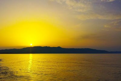 Scenic view of sea and mountains during sunset