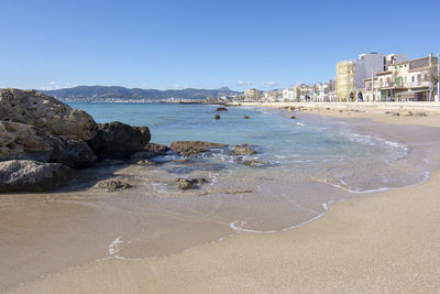 Scenic view of beach against clear sky