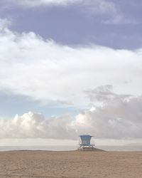 Lifeguard hut at beach against sky