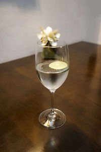 Close up glass of sparkling water on wooden table