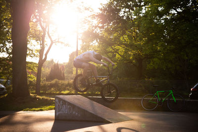 Man riding bicycle against trees