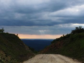 Scenic view of mountains against cloudy sky