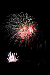 Low angle view of firework display at night