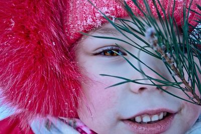 Close-up portrait of cute girl in red knit hat