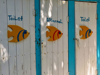 Fish shapes and text on outhouse