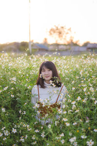 Portrait of woman standing on field